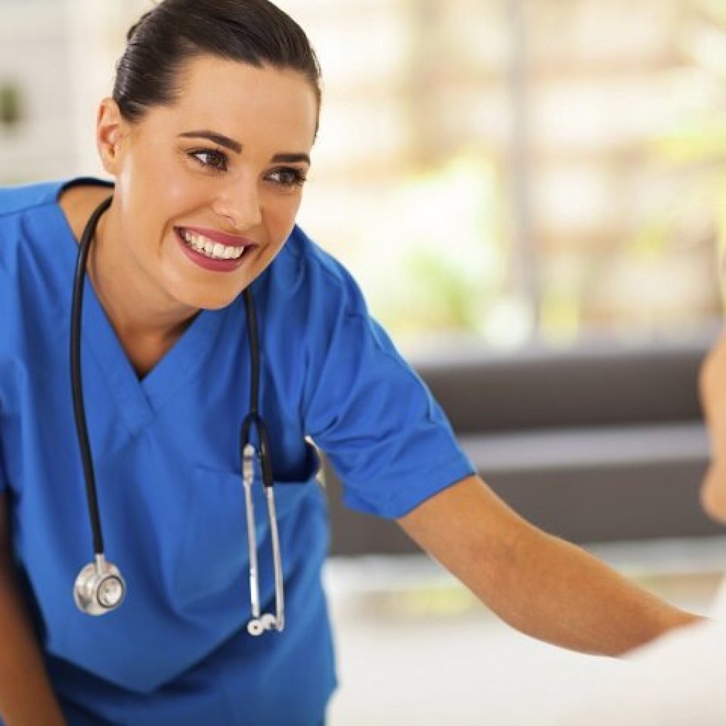 friendly young nurse talking to senior patient